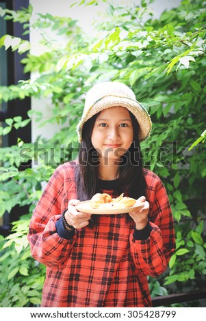 Pretty girl cook hold plate with bakery. Woman in vintage style