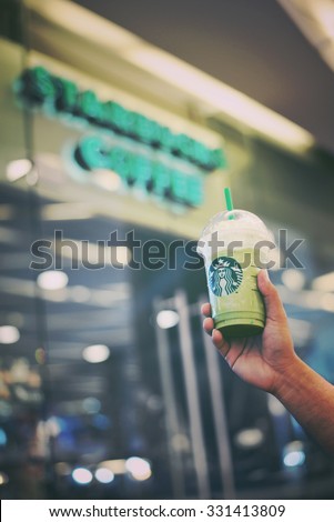 BANGKOK THAILAND- OCTOBER 25: Glass of Starbuck Green tea  smoothie served at wood table in starbuck shop at Department store on October 25, 2015