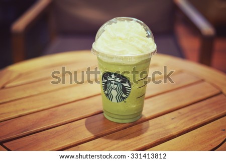 BANGKOK THAILAND- OCTOBER 25: Glass of Starbuck Green tea  smoothie served at wood table in starbuck shop at Department store on October 25, 2015