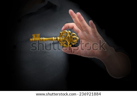 Businessman showing the golden crown key to success