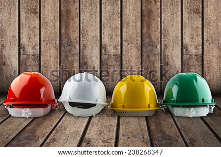 safety helmet and architect plant on wood background.
