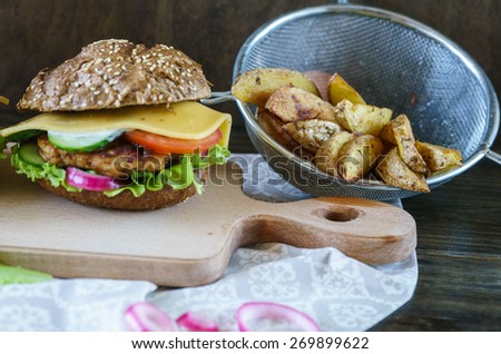 Homemade Chicken Hamburger on White and Brown Bread with Fried Potatoes.