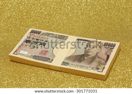 Stack of one million yen bills on gold background