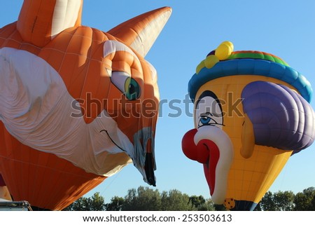 Ferrara, Italia - September 14, 2014: The photo was made at the Ballons Festival at Ferrara on september 14, 2014.A hot air balloon shaped like a clown and a fox gets up in the sky
