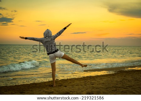 flying woman on the beach, sunset