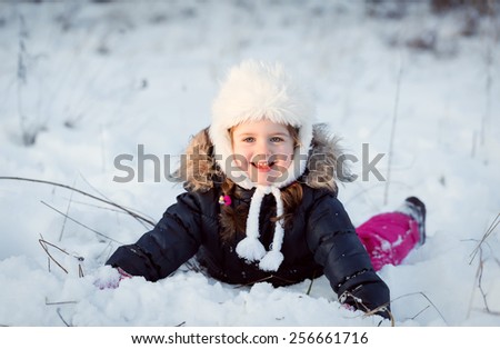Happy child playing with snow, with filter effect