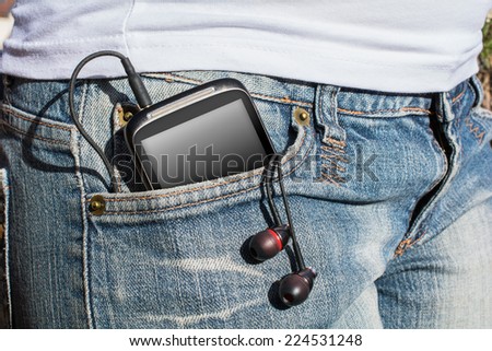 Woman With Smartphone And Headphones In Her Pants Pocket