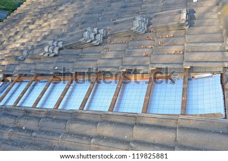 Installing roof insulation in a home to reduce heat wastage and heating bills, and help reduce global warming