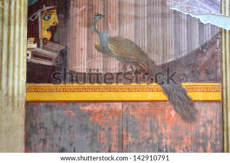 NAPLES, ITALY - MAY 27: Ancient roman fresco of peacock and actor\'s mask in 4th style  in the Villa Oplontis: May  27, 2013 in Naples, Italy