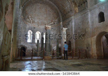 DEMRE, TURKEY - JUNE 27: Man stands alone in the ancient byzantine church of St Nicholas remembering a lost civilisation:  June 27, 2013 in Demre, Turkey