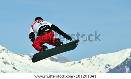 VEYSONNAZ, SWITZERLAND - MARCH 11: Marvin JAMES (SUI) takes to the air in the Snowboard Cross World Cup: March 11, 2014 in Veysonnaz, Switzerland