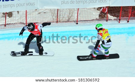 VEYSONNAZ, SWITZERLAND - MARCH 11: SCHAD (GER) leads PERATHONER (ITA)  in the Snowboard Cross World Cup: March 11, 2014 in Veysonnaz, Switzerland