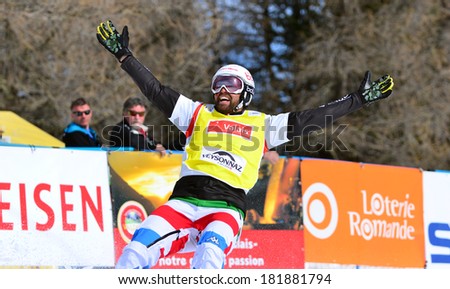 VEYSONNAZ, SWITZERLAND - MARCH 11: Fabio CORDI (ITA) celebrates victory in the Snowboard Cross World Cup finals : March 11, 2014 in Veysonnaz, Switzerland