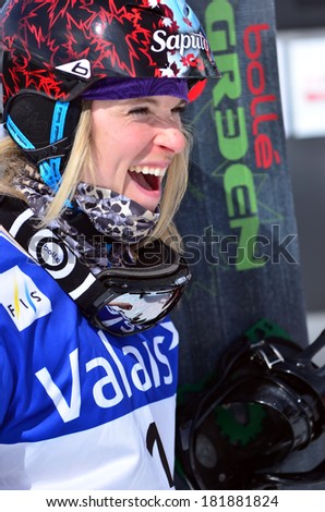 VEYSONNAZ, SWITZERLAND - MARCH 11: Dominique MALTAIS (CAN) on the podium in the Snowboard Cross World Cup: March 11, 2014 in Veysonnaz, Switzerland