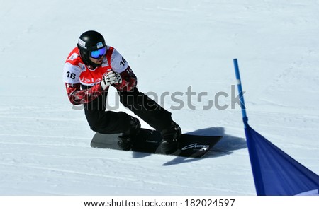 VEYSONNAZ, SWITZERLAND - MARCH 11: Jake HOLDEN (CAN) going fast in the Snowboard Cross World Cup: March 11, 2014 in Veysonnaz, Switzerland