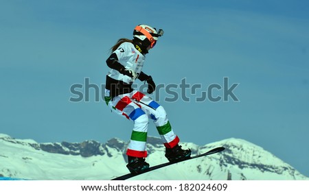 VEYSONNAZ, SWITZERLAND - MARCH 11: Zoe BERGERMANN (CAN) in the air in the Snowboard Cross World Cup: March 11, 2014 in Veysonnaz, Switzerland
