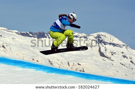 VEYSONNAZ, SWITZERLAND - MARCH 11: Zoe GILLINGS (GBR) jumping in the Snowboard Cross World Cup: March 11, 2014 in Veysonnaz, Switzerland