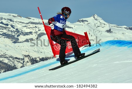 VEYSONNAZ, SWITZERLAND - MARCH 11: World Champion Dominique MALTAIS (CAN) prepares for a big jump in the Snowboard Cross World Cup: March 11, 2014 in Veysonnaz, Switzerland