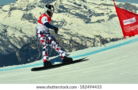 VEYSONNAZ, SWITZERLAND - MARCH 11: Nikolay OLYUNIN (RUS) in the Snowboard Cross World Cup: March 11, 2014 in Veysonnaz, Switzerland