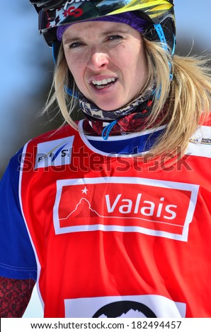 VEYSONNAZ, SWITZERLAND - MARCH 11: World Champion Dominique MALTAIS (CAN) in the Snowboard Cross World Cup: March 11, 2014 in Veysonnaz, Switzerland