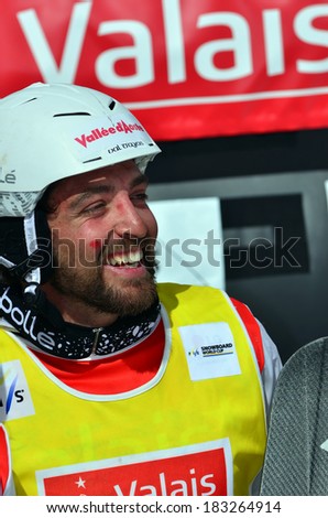 VEYSONNAZ, SWITZERLAND - MARCH 11: Champion Fabio CORDI (ITA) on the podium in the Snowboard Cross World Cup: March 11, 2014 in Veysonnaz, Switzerland