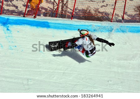 VEYSONNAZ, SWITZERLAND - MARCH 11: Zoe BERGERMANN (CAN) on a fast bend in the Snowboard Cross World Cup: March 11, 2014 in Veysonnaz, Switzerland