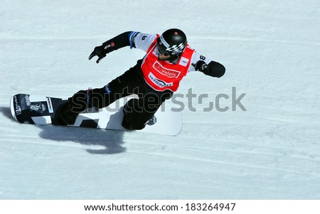 VEYSONNAZ, SWITZERLAND - MARCH 11: Konstantin SCHAD (GER) on a fast bend in the Snowboard Cross World Cup: March 11, 2014 in Veysonnaz, Switzerland