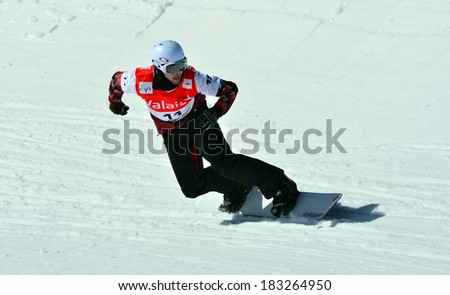 VEYSONNAZ, SWITZERLAND - MARCH 11: Kevin HILL (CAN) competing in the Snowboard Cross World Cup: March 11, 2014 in Veysonnaz, Switzerland