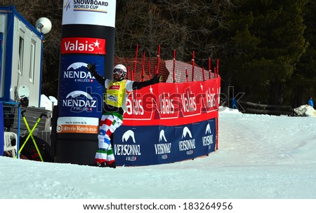 VEYSONNAZ, SWITZERLAND - MARCH 11: World Champion Fabio CORDI  (ITA) crosses the line in the Snowboard Cross World Cup: March 11, 2014 in Veysonnaz, Switzerland