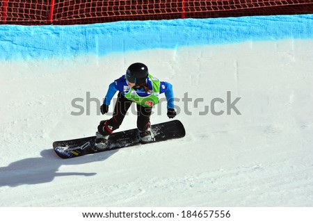 VEYSONNAZ, SWITZERLAND - MARCH 11: Maria RAMBERGER (AUT) on a fast bend in the Snowboard Cross World Cup: March 11, 2014 in Veysonnaz, Switzerland