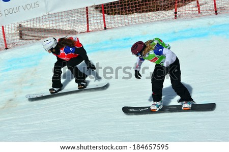 VEYSONNAZ, SWITZERLAND - MARCH 11: JEKOVA (BUL) leads BANKES (FRA) in the Snowboard Cross World Cup: March 11, 2014 in Veysonnaz, Switzerland