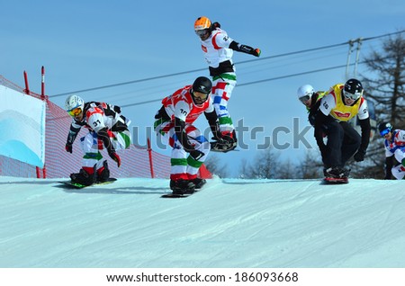 VEYSONNAZ, SWITZERLAND - MARCH 11: GODINO 10 (ITA) leading the pack in the Snowboard Cross World Cup: March 11, 2014 in Veysonnaz, Switzerland