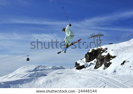 Aeroski: a skier executing a tele-heli with his skis crossed during a jump