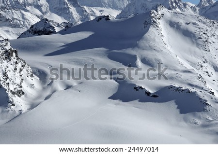 Swiss alps. Helicopter skiing. Ski tracks left in the powder snow on the Rosablanche.