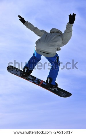 Airoski: a snowboarder  with blue pants on a high jump