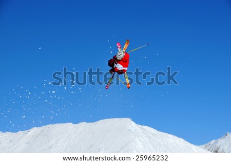 a ski jumper with a spray of snow particles caused by his take-off