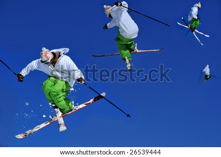 sequence of 4 shots showing a skier in green and white performing a tele-heli with crossed skis. the sequence shows the progress of the spin with crossed skis from a reverse take-off (left)