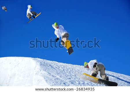 sequence of a snowboarder coming in to land during a high jump. This is a composite image shot in the chronological order of left to right