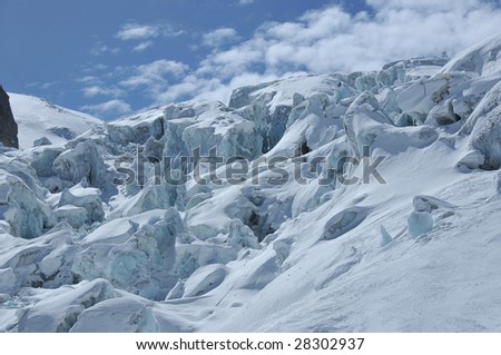 a large ice fall on a glacier. Towering seracs (blocks of ice) fall down a steep slope in violent abandon. This glacier is rapidly melting, and will eventually disappear due to global warming
