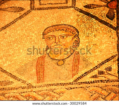 golden roman mosaic portrait  of a grumpy looking man. This portrait is 1700 years old.