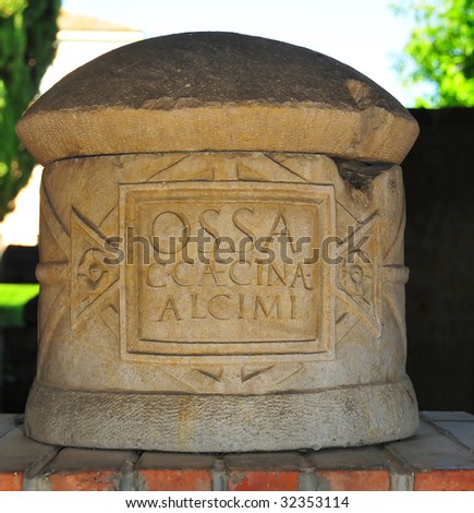 a carved stone burial urn comprising of a stone lid and stone jar with an inscription mentioning the deceased