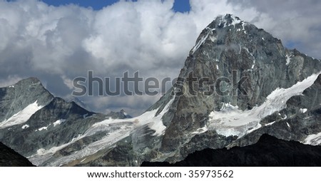 The high mountain of the Dent Blanche a challenging peak for climbers with the lesser peak of the Grand Cornier on the left.