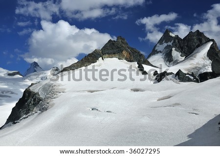 the swiss alps and glaciers on the italian border, part of the famous haute route which crosses from chamonix to Zermatt. On the left the dent d\'herens, on the right the dents de bouquetin