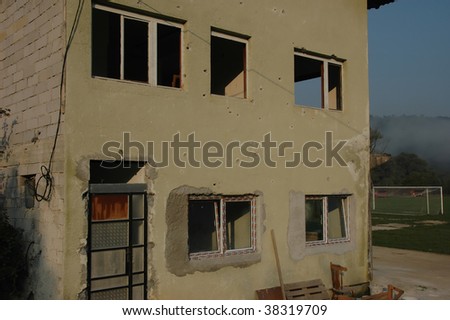 The football stadium guesthouse being restored with new windows following the war in Bosnia. It was attacked by serbian troops coming from neighbouring serbian village. Bullet holes cover the walls.