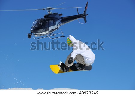 stock photo : a snowboarder jumping being filmed by a specially adapted 