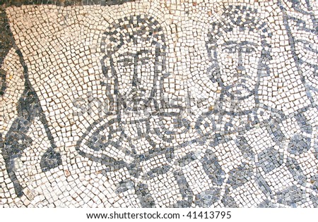 two sad faces looking out of a window on a roman mosaic