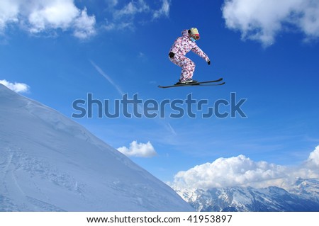 a girl ski jumper without sticks jumps off a high snow bank
