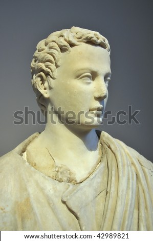 ancient greek sculpture carved from marble of a magnificent looking man