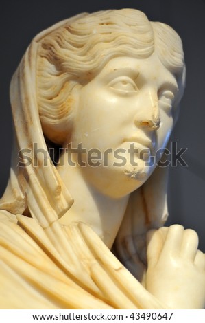 a beautiful classical roman statue of a woman (Cornelia Antonia) in luminous marble