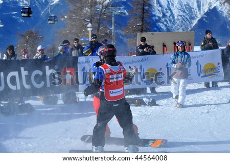 VEYSONNAZ, SWITZERLAND - JANUARY 15:  FIS World Championship Snowboard Cross finals. World champion Pierre Vaultier, congratulates 2nd Speiser in spray of snow. January 15 in Veysonnaz, Switzerland